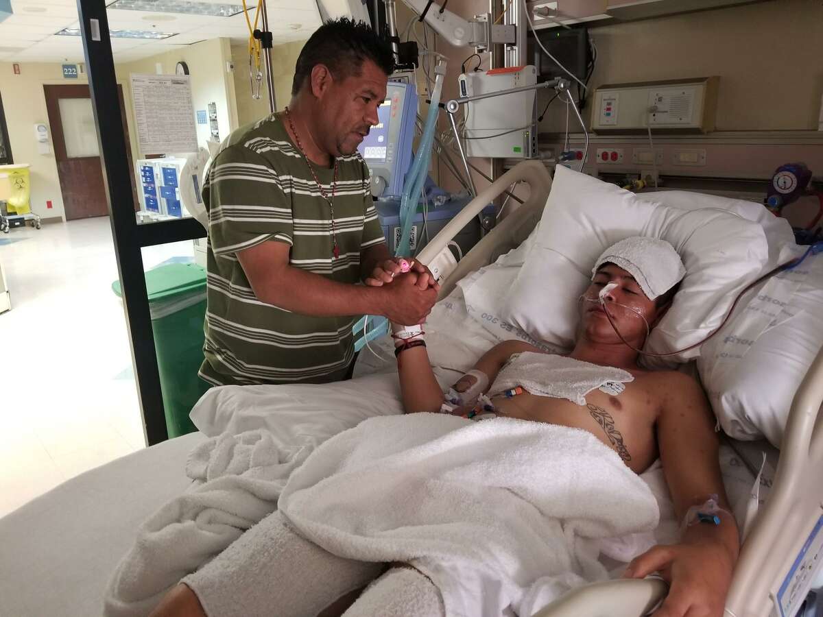 Jose De Jesus Martinez Delgado (left) came from Denver to North Central Baptist Hospital see his 16-year-old son Brandon Rodrigo Martinez Deloera. Brandon is in intensive care with damage to the brain, lungs and liver after spending hours inside a sweltering truck transporting undocumented immigrants Sunday.