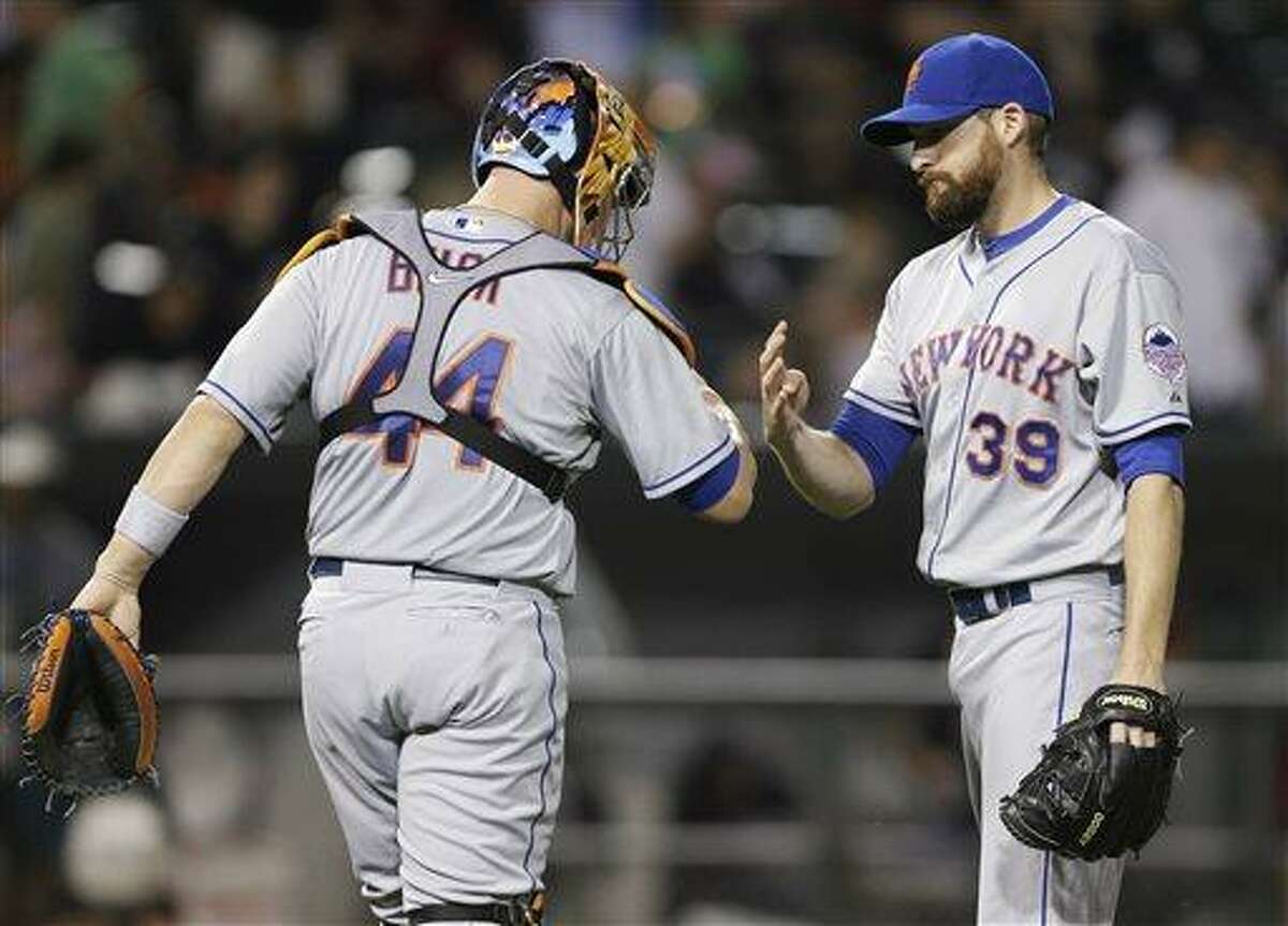 New York Mets closer Bobby Parnell, right, celebrates with catcher John Buck after the Mets defeated the Chicago White Sox 3-0 in an interleague baseball game Wednesday, June 26, 2013, in Chicago. The Mets won 3-0. (AP Photo/Nam Y. Huh)
