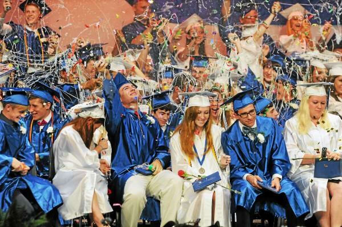 Catherine Avalone/The Middletown Press Coginchaug's class of 2013 celebrate with silly string and beach balls after receiving their diplomas at the Julian B. Thayer Auditorium Tuesday night at graduation.