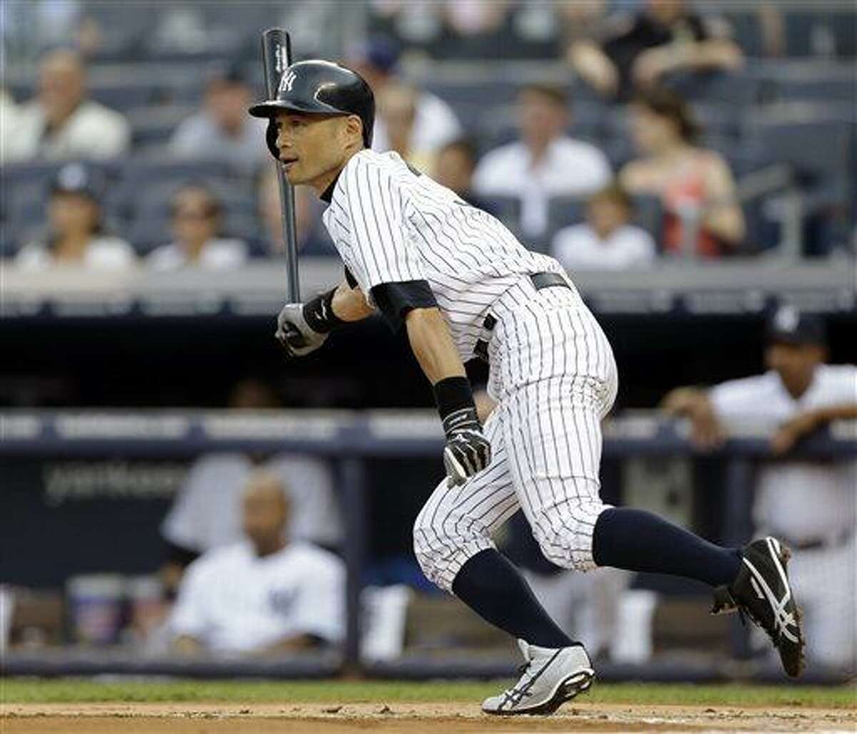 New York Yankees' Ichiro Suzuki follows through on a base hit off Texas Rangers starting pitcher Yu Darvish in the first inning of a baseball game Tuesday, June 25, 2013, in New York. (AP Photo/Kathy Willens)