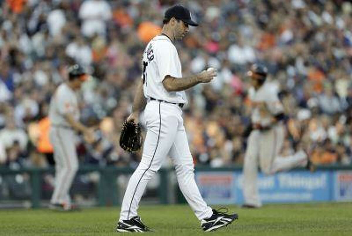 Detroit Tigers pitcher Justin Verlander looks at a ball after giving up a Baltimore Orioles' Adam Jones three-run home run in the fifth inning of a baseball game in Detroit, Tuesday, June 18, 2013.
