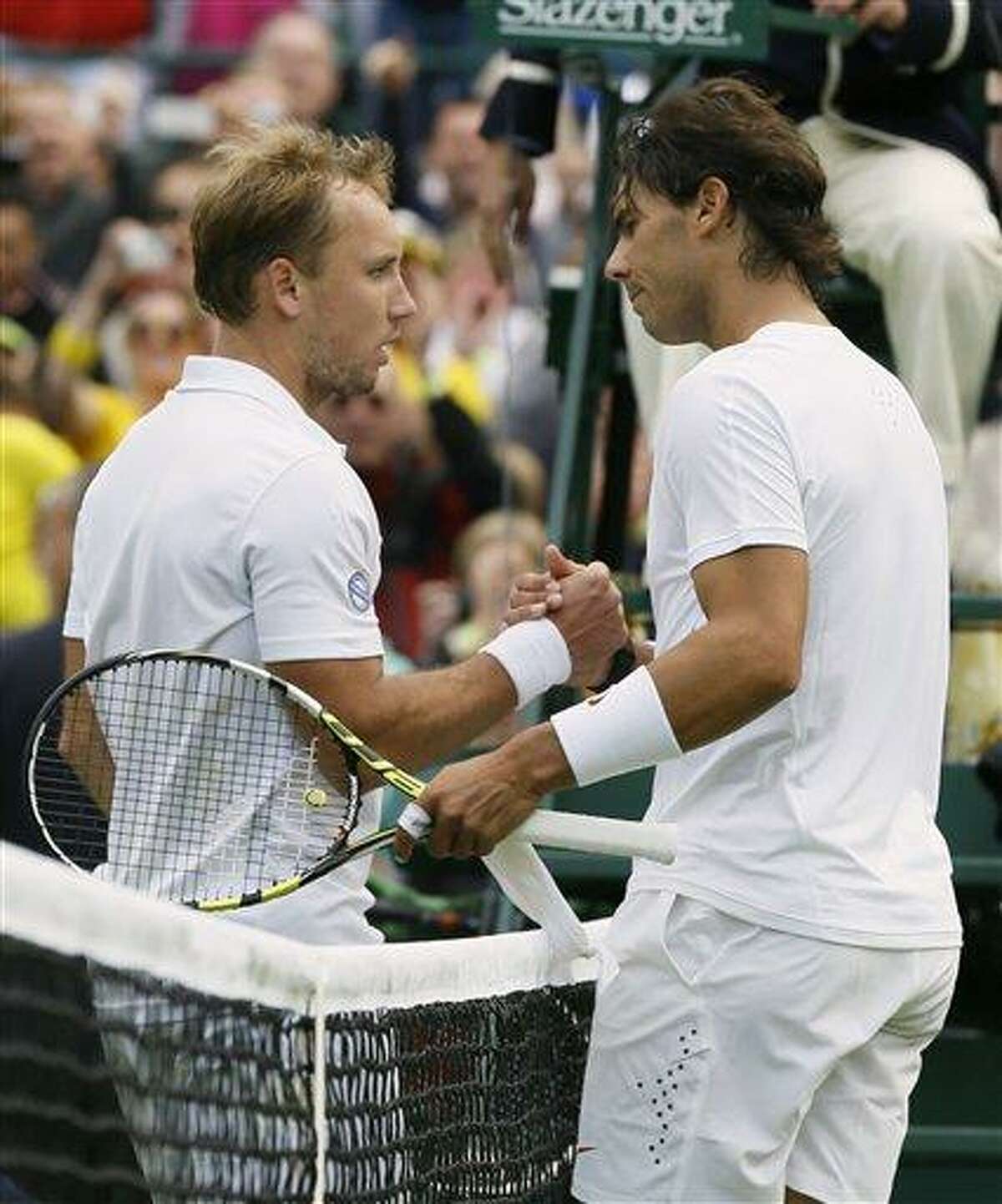 Rafael Nadal of Spain shakes hands with Steve Darcis of Belgium after he lost following their Men's first round singles match at the All England Lawn Tennis Championships in Wimbledon, London, Monday, June 24, 2013. (AP Photo/Kirsty Wigglesworth)