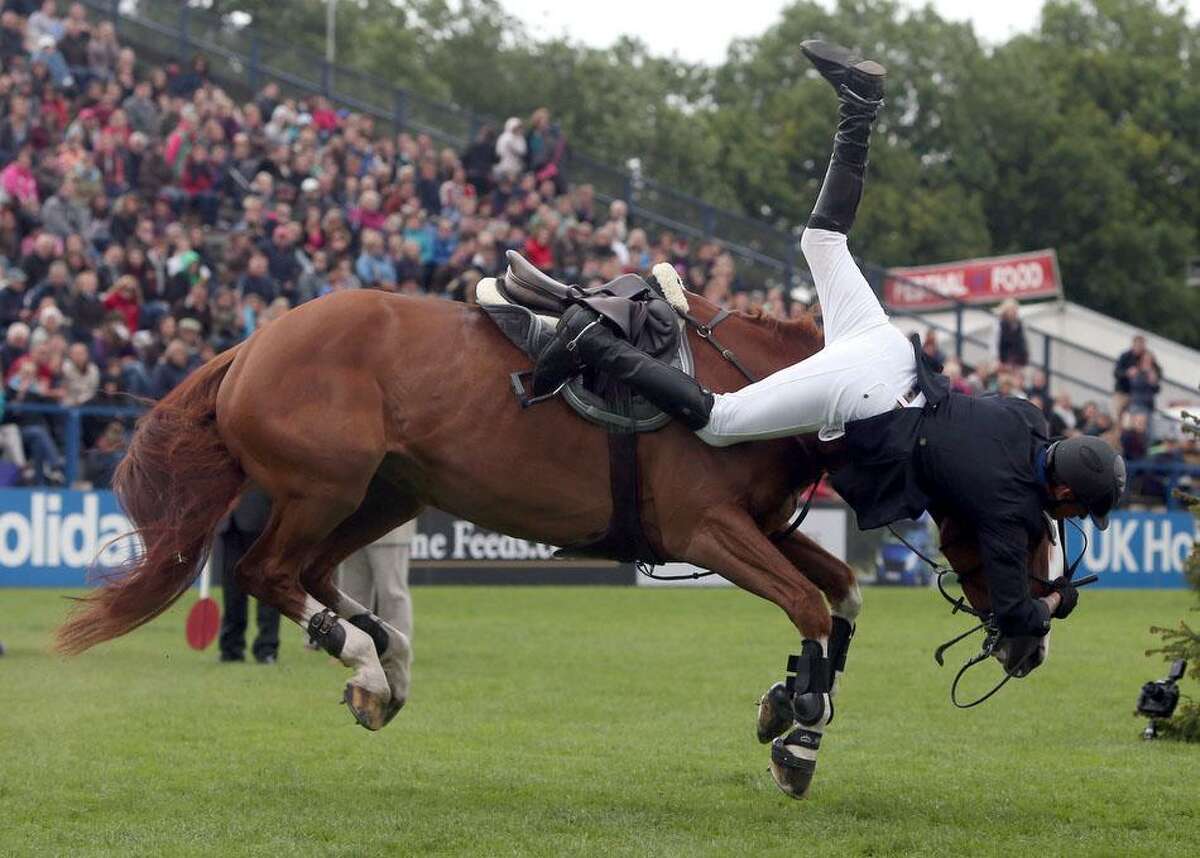 Britain's Joao Charlesworth riding Hartleymanor Venus has trouble as they come down off the Derby Bank during the Hickstead Derby at the The All England Jumping Course, Hickstead, Engalnd, Sunday June 23, 2013. The horse and rider were shaken by the event but seemed unhurt. (AP Photo / Steve Parsons, PA)