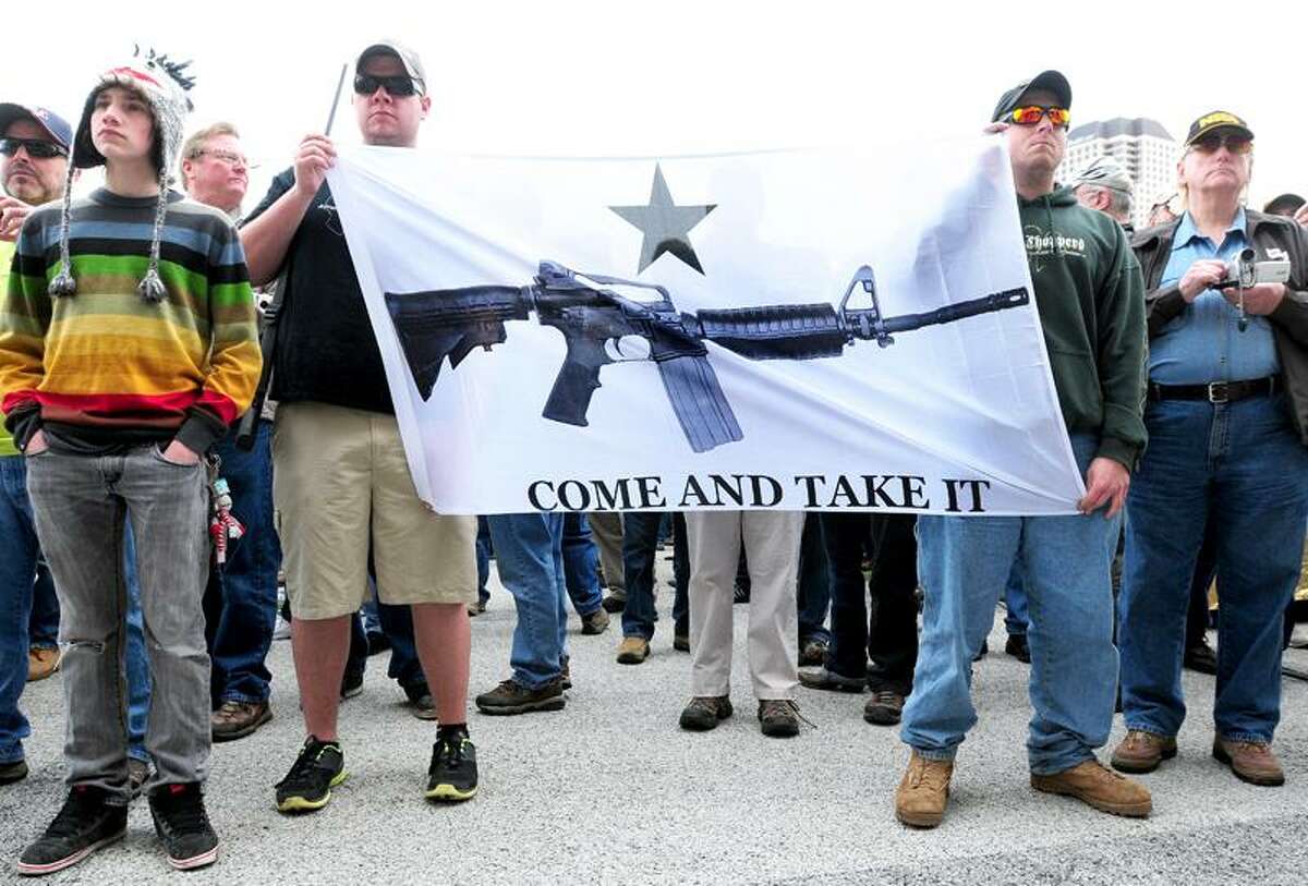 Brian Stevens (left) and Todd Nihill (right) of Seymour hold a banner of an AR-15 semi-automatic rifle during a rally supporting the repeal of Connecticut's new gun laws in front of the Capitol in Hartford on 4/20/2013.Photo by Arnold Gold/New Haven Register AG0493B