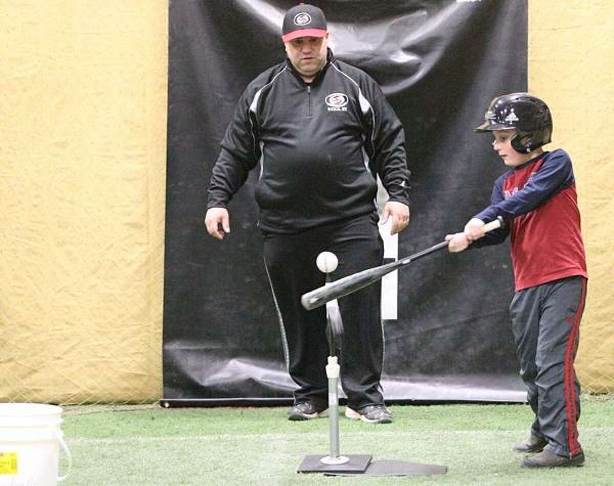 Dispatch Staff Photo by JOHN HAEGER twitter.com/oneidaphoto Dave Muraco works with Devin Smith during a hitting lesson in Canastota on Thursday, Feb. 14, 2013