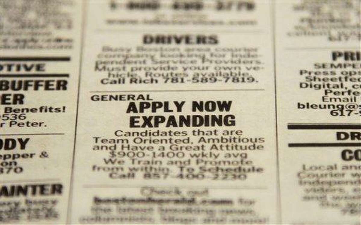 In this Tuesday, Dec. 11, 2012 photo taken in Walpole, Mass., an advertisement in the classified section of the Boston Herald newspaper calls attention to possible employment opportunities. The number of Americans seeking unemployment benefits fell sharply for a fourth straight week, a sign that the job market may be improving. The Labor Department said Thursday, Dec. 13, 2012, that weekly applications for unemployment benefits fell 29,000 last week to a seasonally adjusted 343,000, the lowest in two months. It is the second-lowest total this year. (AP Photo/Steven Senne)