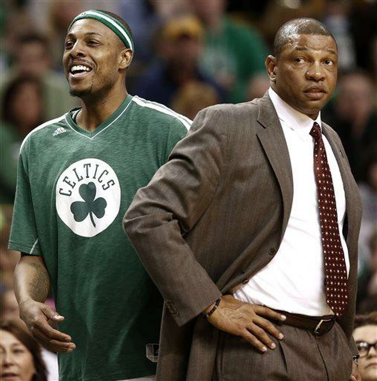Boston Celtics' Paul Pierce, left, smiles next to head coach Doc Rivers during the fourth quarter of their 107-96 win over the Washington Wizards in an NBA basketball game in Boston, Sunday, April 7, 2013. (AP Photo/Winslow Townson)