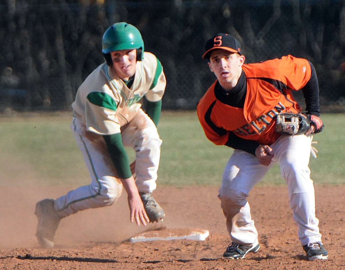 Wesley Paulson of Notre Dame-West Haven holds at second as Tyler Tice of Shelton watches a play at first base during third inning from action earlier this month. Notre Dame lost to Xavier on Friday. Photo by Peter Hvizdak / New Haven Register.