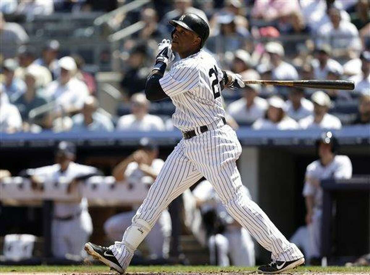 New York Yankees Robinson Cano hits a first-inning sacrifice fly in a baseball game against the Tampa Bay Rays, Sunday, June 23, 2013, in New York. (AP Photo/Kathy Willens)