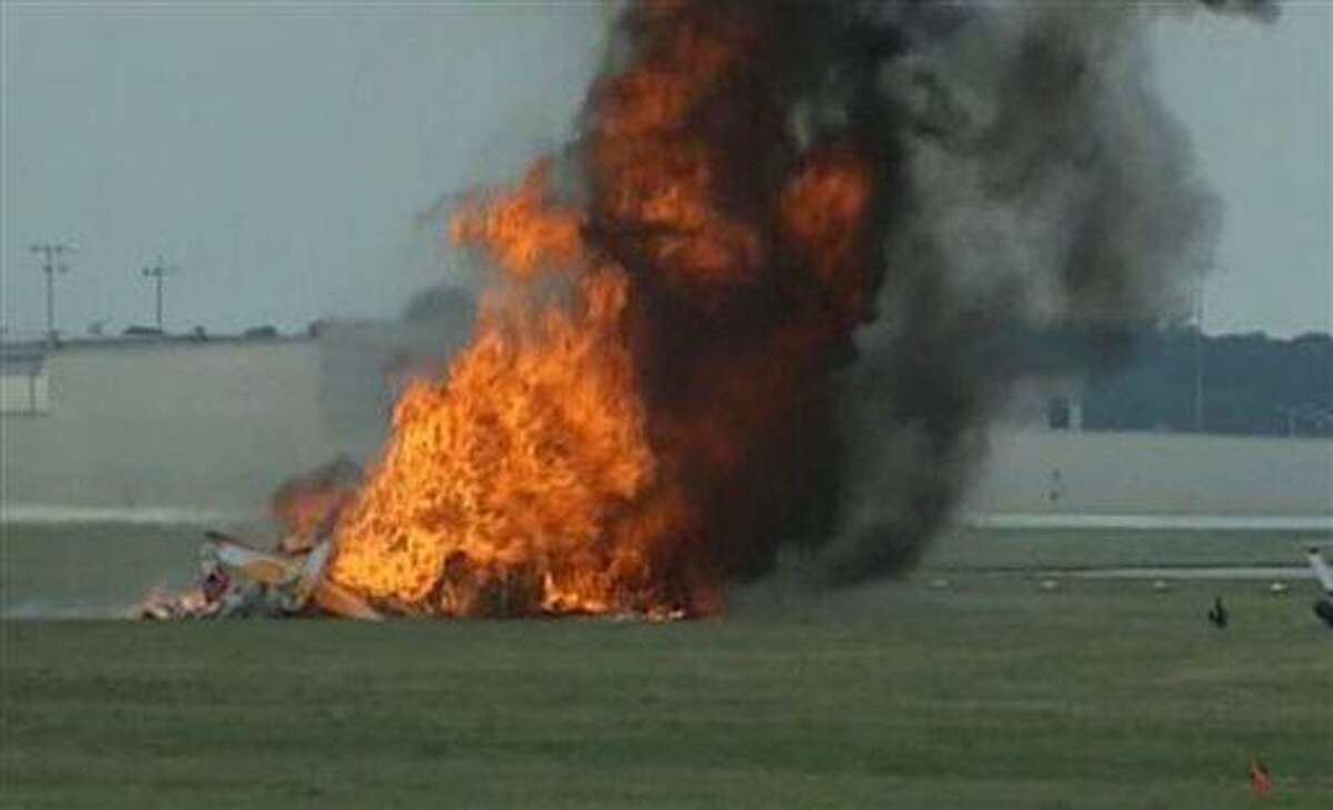 This photo provided provided WHIO TV shows a plane after it crashed Saturday, June 22, 2013, at the Vectren Air Show near Dayton, Ohio. There was no immediate word on the fate of the pilot, wing walker or anyone else aboard the plane. No one on the ground was hurt. (AP Photo/WHIO-TV)