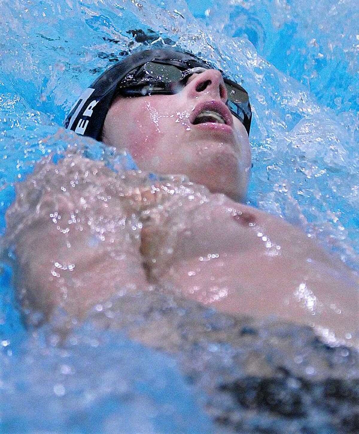 Catherine Avalone/The Middletown PressXavier sophomore Michael Primer placed first in the 100 yard backstroke with an official itme of 1:02.56 against Cheshire Friday night at the Wesleyan University Natatorium at Freeman Athletic Center in Middletown. Xavier defeated Cheshire 99-85.