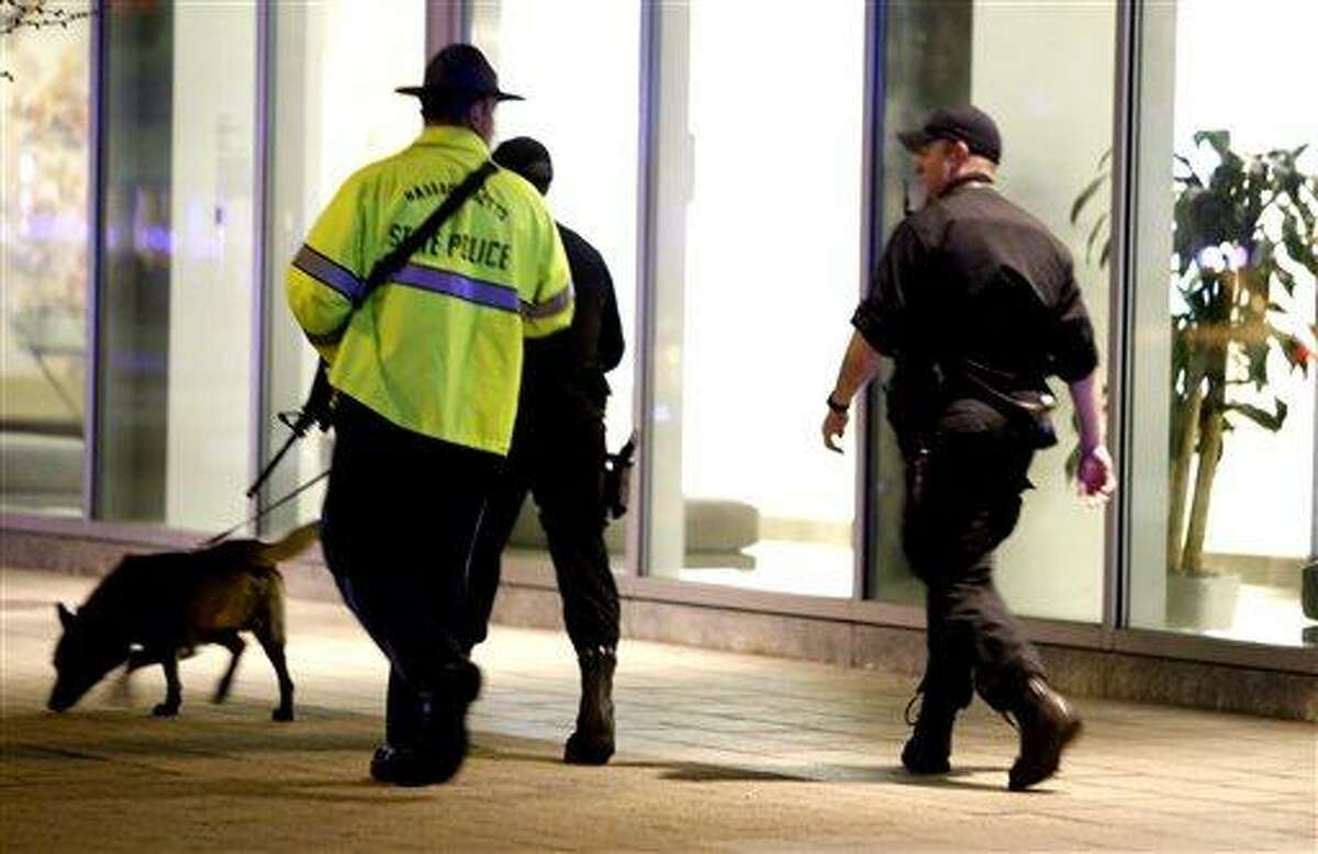 Officials patrol an area at Massachusetts Institute of Technology following reports of a shooting, Thursday, April 18, 2013, in Boston. State police say a campus police officer at the school has died from injuries in a shooting on the campus outside Boston. State police spokesman Dave Procopio says the shooting took place about 10:30 p.m. outside an MIT building. The officer was described as a male but no further information about him was released. The city continues to cope following Monday's explosions near the finish line of the Boston Marathon. (AP Photo/Julio Cortez)