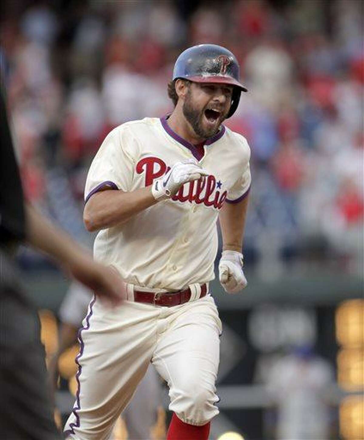 Philadelphia Phillies' Kevin Frandsen runs the bases after he hit a solo home run against the New York Mets in the ninth inning of a baseball game Saturday, June 22, 2013, in Philadelphia. The Phillies won 8-7. (AP Photo/H. Rumph Jr)