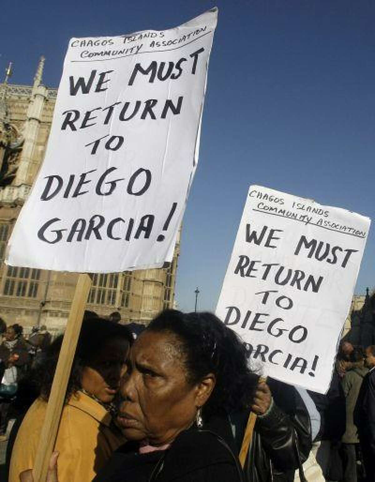 Women take part in a protest outside the Houses of Parliament in London, after a court ruling decided Chagos Islanders are not allowed to return to their homeland, Wednesday Oct. 22, 2008.