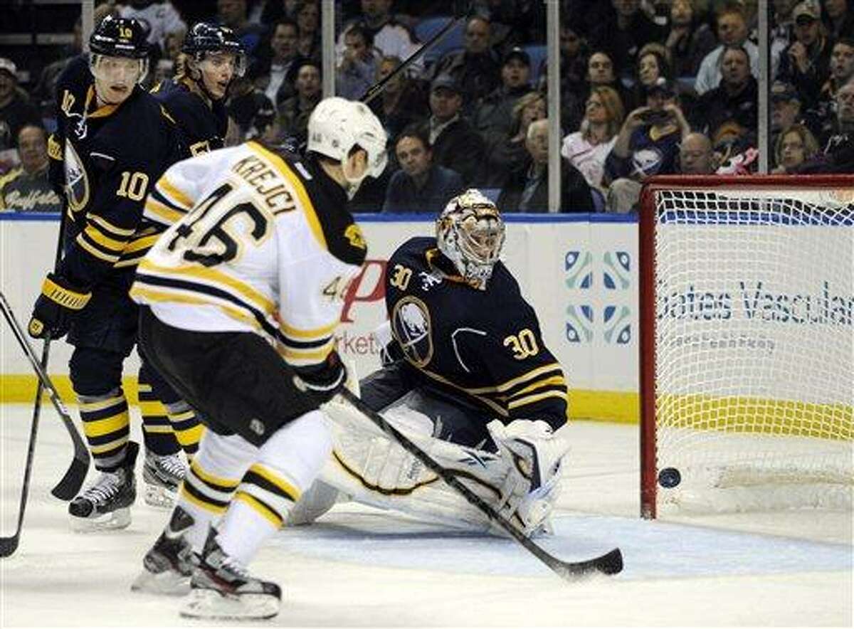 Boston Bruins center David Krejci, (46), of the Czech Republic, watches the puck hit the goalpost as Buffalo Sabres defenseman Christian Ehrhoff (10), of Germany, and goaltender Ryan Miller (30) react during the second period of an NHL hockey game in Buffalo, N.Y., Friday, Feb. 15, 2013. (AP Photo/Gary Wiepert)