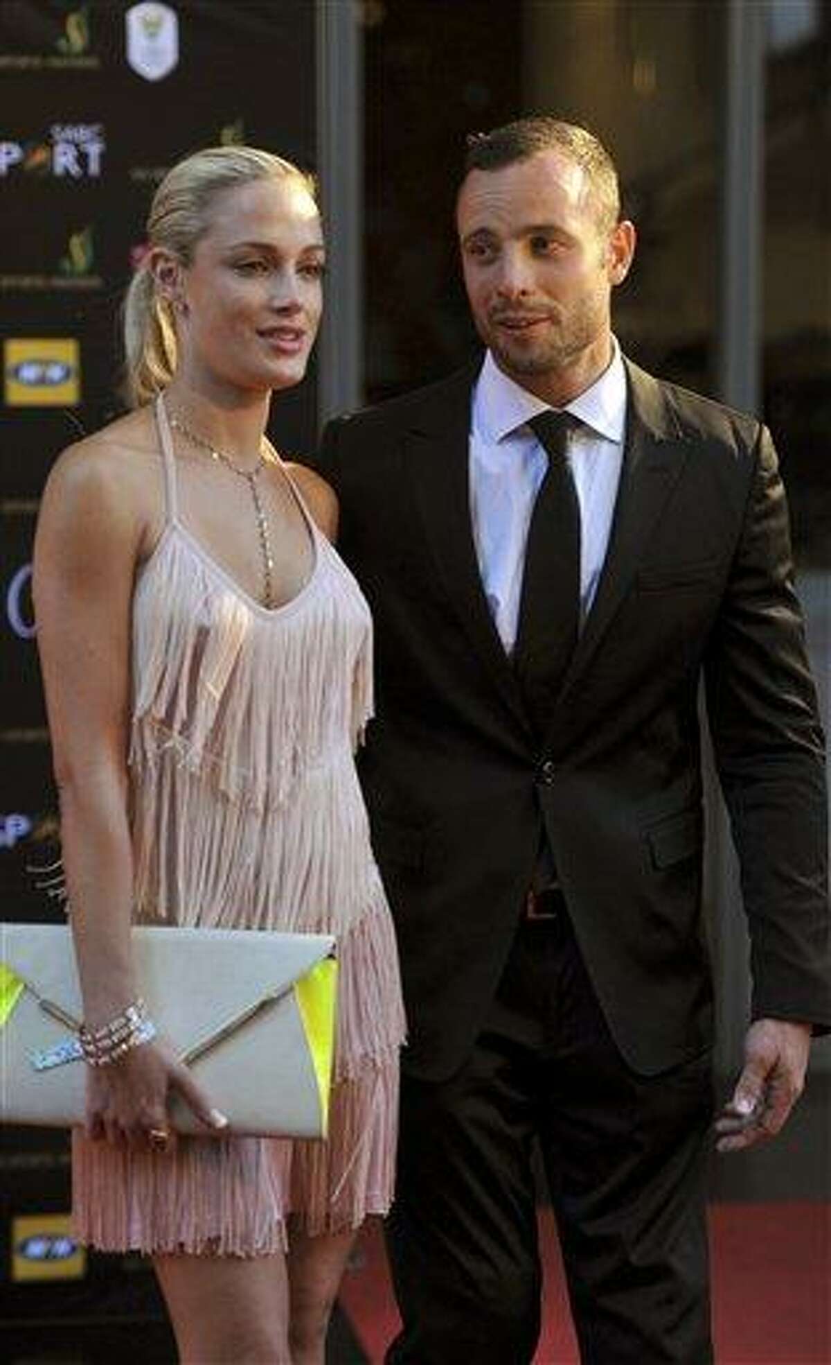In this Nov. 4, 2012 photo, South African Olympic athlete Oscar Pistorius and Reeva Steenkamp, believed to be his girlfriend, at an awards ceremony, in Johannesburg, South Africa. Olympic athlete Oscar Pistorius was taken into custody and was expected to appear in court Thursday, Feb. 14, 2013, after a 30-year-old woman who was believed to be his girlfriend was shot dead at his home in South Africa's capital, Pretoria. (AP Photo/Lucky Nxumalo-Citypress) SOUTH AFRICA OUT