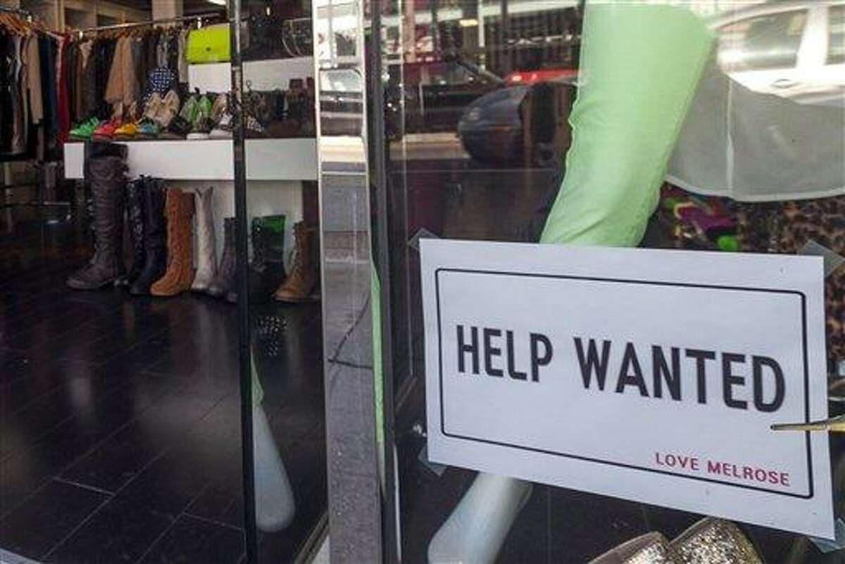 A help wanted sign is posted in December 2012 on the front window of a clothing boutique in Los Angeles. Associated Press file photo