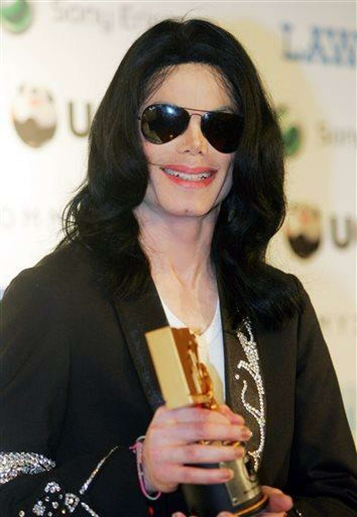 FILE - In this May 27, 2006 file photo, Michael Jackson smiles during a press conference of the MTV Video Music Awards Japan 2006 in Tokyo. The U.S. entertainer was awarded a Legend Award at the ceremony. Jurors hearing a civil case in Los Angeles filed by Jackson's mother, Katherine Jackson, have heard numerous stories about the entertainer's devotion to his children as expressed through extravagant birthday parties and secret family outings. The tender moments have been described throughout the trial, which concluded its eighth week on Friday, June 21, 2013. (AP Photo/Koji Sasahara, File)