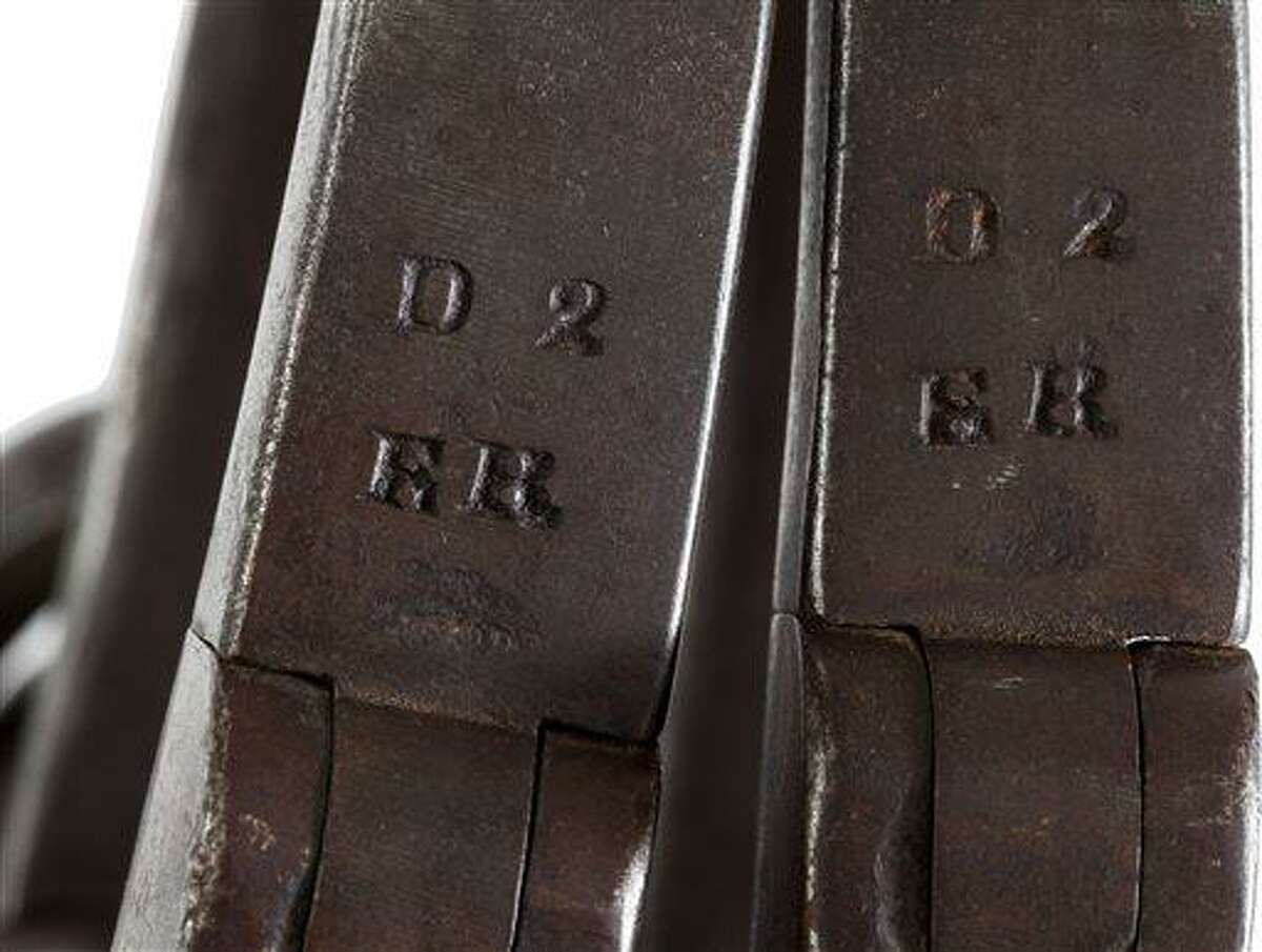 This June 17, 2013 provided by Heritage Auctions, shows a close-up of the leg irons that were placed on John Brown shortly after his arrest at Harper's Ferry, W.Va. The irons are stamped "ER" in two places. The initials "ER" stand for Elijah Rickard, a well-known locksmith who operated out of Shepherdstown, Virginia. believed to be those used on John Brown during his incarceration at the Charlestown, W.Va., jail following his arrest during the raid at Harper's Ferry W.Va. John Brown's capture of the Federal Arsenal at Harper's Ferry on Oct. 17, 1859 as part of a failed attempt to incite a slave uprising is seen by most historians as the spark that ignited the Civil War. They have been passed down in the family of John Boling, of Idaho, for six generations, after being obtained by a decedent shortly after Brown's execution. They are expected to bring more than $10,000 when they come up for auction on June 22, 2013. (AP Photo/Heritage Auctions)