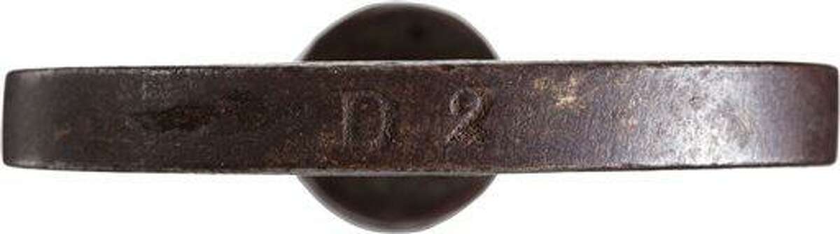 This June 17, 2013 photo provided by Heritage Auctions, shows a close-up of the marking, "D2" on the left-handed thread key that locked and unlocked the leg irons that held abolitionist John Brown during his arrest after his botched raid on Harper's Ferry, W.Va., on Oct. 17, 1859. It is unknown what "D2" stands for. The key accompanies the leg irons, Charlestown, W.Va., jail following his arrest during the raid at Harper's Ferry W.Va. John Brown's capture of the Federal Arsenal at Harper's Ferry on Oct. 17, 1859 as part of a failed attempt to incite a slave uprising is seen by most historians as the spark that ignited the Civil War. They have been passed down in the family of John Boling, of Idaho, for six generations, after being obtained by a decedent shortly after Brown's execution. They are expected to bring more than $10,000 when they come up for auction on June 22, 2013. (AP Photo/Heritage Auctions)