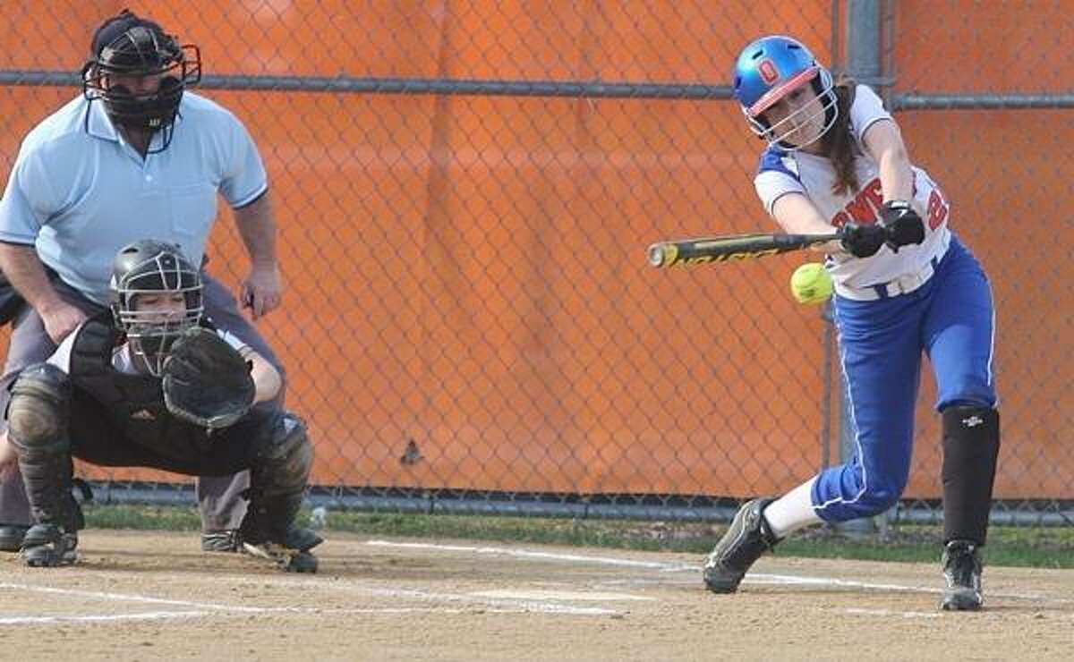 PHOTO BY JOHN HAEGER @ ONEIDAPHOTO ON TWITTER/ONEIDA DAILY DISPATCH Oneida's Samantha Lusher (23) connects for a single as Canastota catcher Julia Collins looks on during the bottom of the fifth inning at Oneida on Thursday, April 18, 2013.