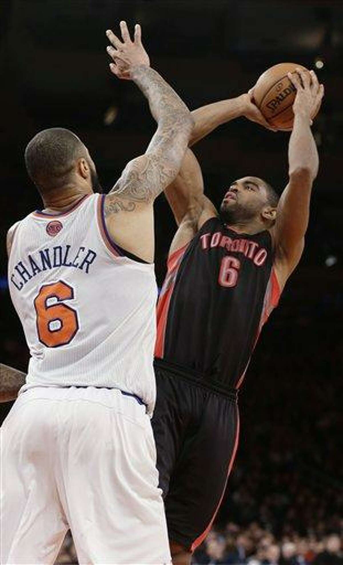 Toronto Raptors' Alan Anderson (6) shoots over New York Knicks' Tyson Chandler (6) during the second half of an NBA basketball game Wednesday, Feb. 13, 2013, in New York. Anderson scored 26 points as the Raptors won 92-88. (AP Photo/Frank Franklin II)
