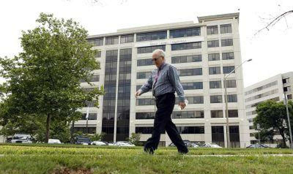 A man walks pass the Booz Allen Hamilton Holding Corp building in McLean, Va., on June 11, 2013.