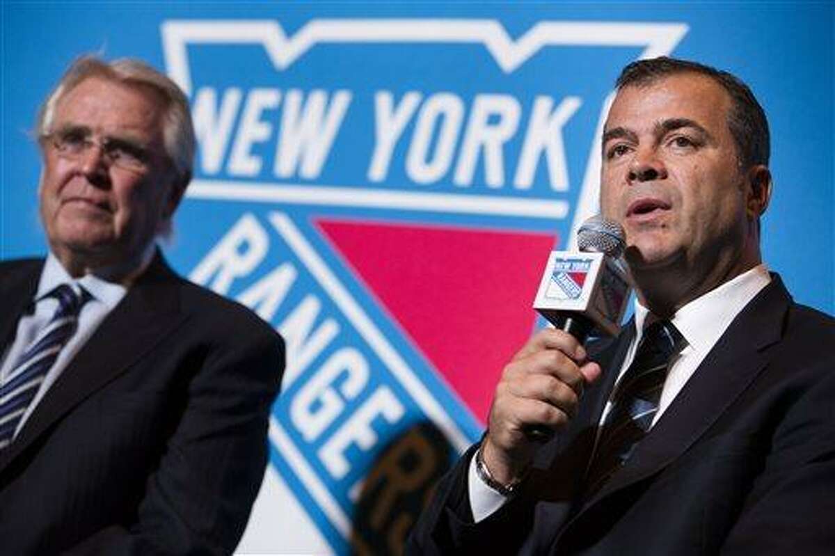New York Rangers new hockey head coach Alain Vigneault, right, speaks during a news conference alongside Rangers president and general manager Glen Sather, at Radio City Music Hall, Friday, June 21, 2013, in New York. Vigneault, 52, comes to the Rangers after seven years as coach of the Vancouver Canucks. (AP Photo/John Minchillo)