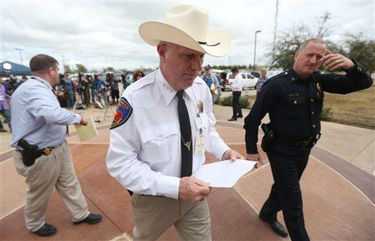 Kaufman County Sheriff David Byrnes, center, walks away after a news conference in Kaufman, Texas, on Sunday March 31, 2013. On Saturday, Kaufman County District Attorney Mike McLelland and his wife, Cynthia, were murdered in their home. (AP Photo/Mike Fuentes)