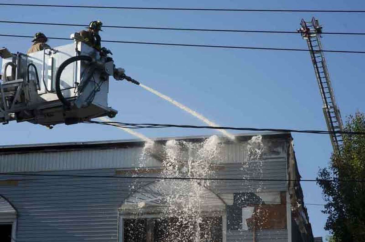 Firefighters fight a fire on Main Street in Madison. VM Williams/Register