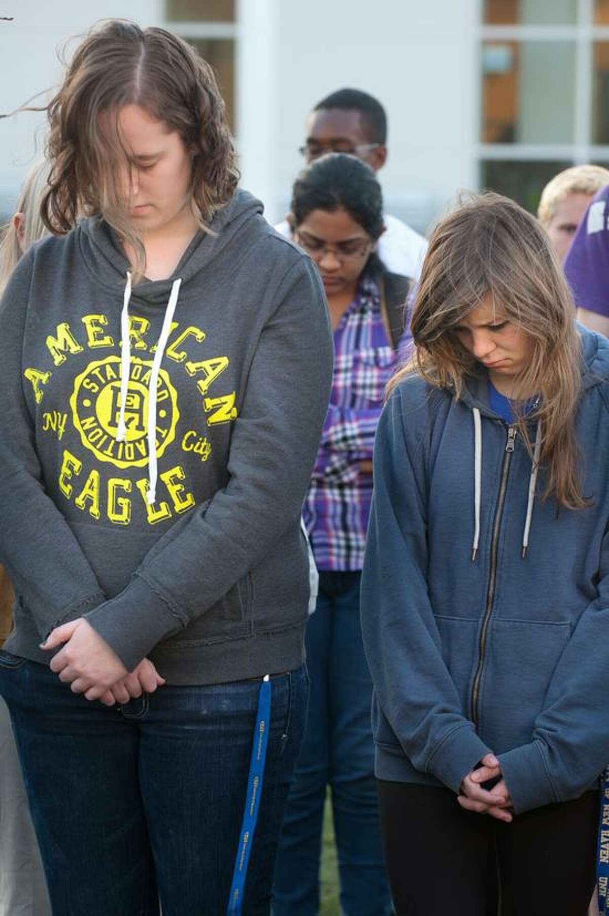 Alaina Kaiser, a sophomore and Marija Savaiko, a freshmen observe a moment of silence during a student vigil at UNH to remember those affected by the events of the Boston Marathon explosions April 17, 2013. vm Williams