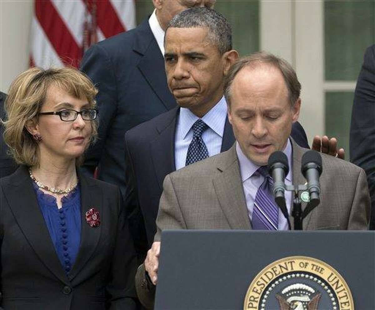 President Barack Obama arrives to participate in a news conference in the Rose Garden of the White House, Wednesday, April 17, 2013, in Washington, about measures to reduce gun violence. With tObama is former Rep. Gabby Giffords, left, and Mark Barden, the father of Newtown shooting victim Daniel. (AP Photo/Carolyn Kaster)