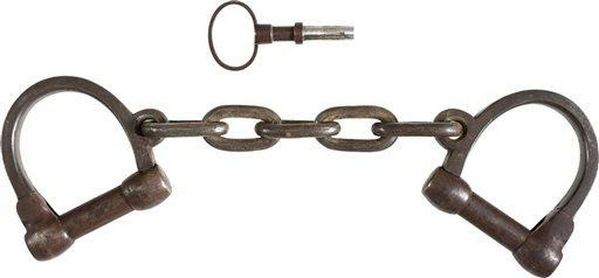 This June 17, 2013 provided by Heritage Auctions, shows the pair of leg irons, or shackles, believed to be those used on John Brown during his incarceration at the Charlestown, W.Va., jail following his arrest during the raid at Harper's Ferry W.Va. John Brown's capture of the Federal Arsenal at Harper's Ferry on Oct. 17, 1859 as part of a failed attempt to incite a slave uprising is seen by most historians as the spark that ignited the Civil War. They have been passed down in the family of John Boling, of Idaho, for six generations, after being obtained by a decedent shortly after Brown's execution. They are expected to bring more than $10,000 when they come up for auction on June 22, 2013. (AP Photo/Heritage Auctions)