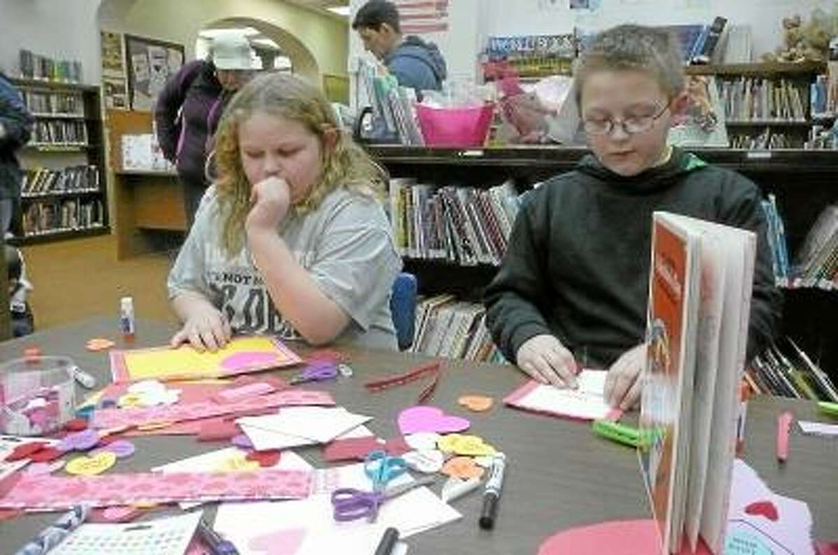 KATE HARTMAN/Register Citizen Local children spent part of their evening at the Torrington Library Wednesday, making cards for parents, friends and teachers.