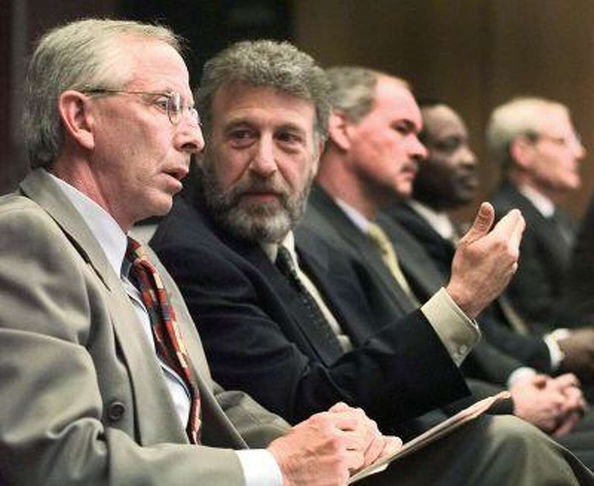 In this Thursday, May 6, 1999 file photo, George Zimmer, second from left, gestures to Andy Dolich prior to a meeting, in Oakland, Calif. (AP Photo/Ben Margot, File)