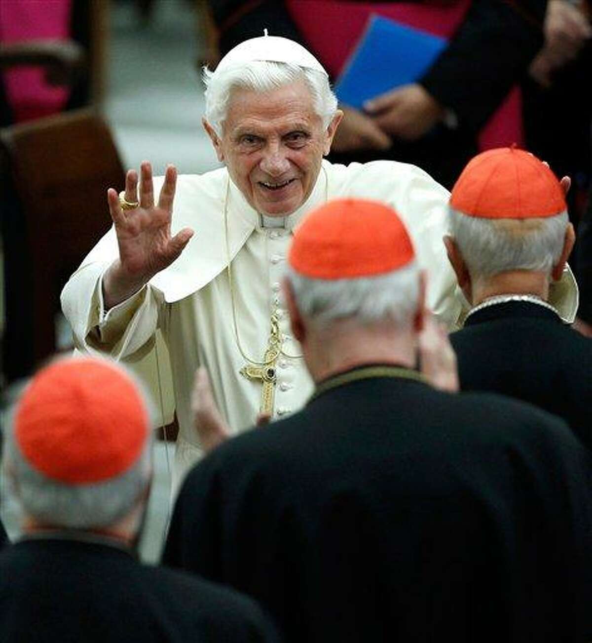 Pope Benedict XVI waving as he leaves Paul VI hall after attending a concert of the Asturias Principality Symphony Orchestra directed by Chilean conductor Maximiano Valdes, at the Vatican. On Monday, Feb. 11, 2013 the Vatican announced that Pope Benedict XVI will resign on Feb. 28, 2013. AP Photo/ Isabella Bonotto