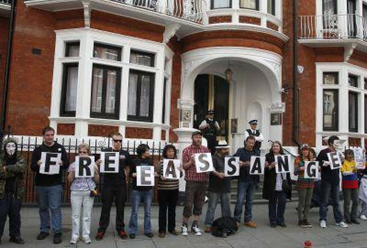 Supporters of WikiLeaks founder Julian Assange stand outside Ecuador's embassy in central London June 16, 2013.