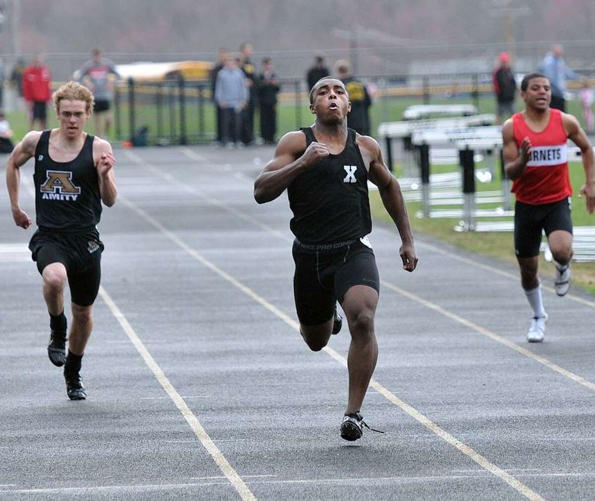 Amity-- Xavier's DeAngelo Berry, center, on his way to a win in the 200-meter at the track meet hosted by Amity High. Photo-Peter Casolino/Register pcasolino@newhavenregister.com