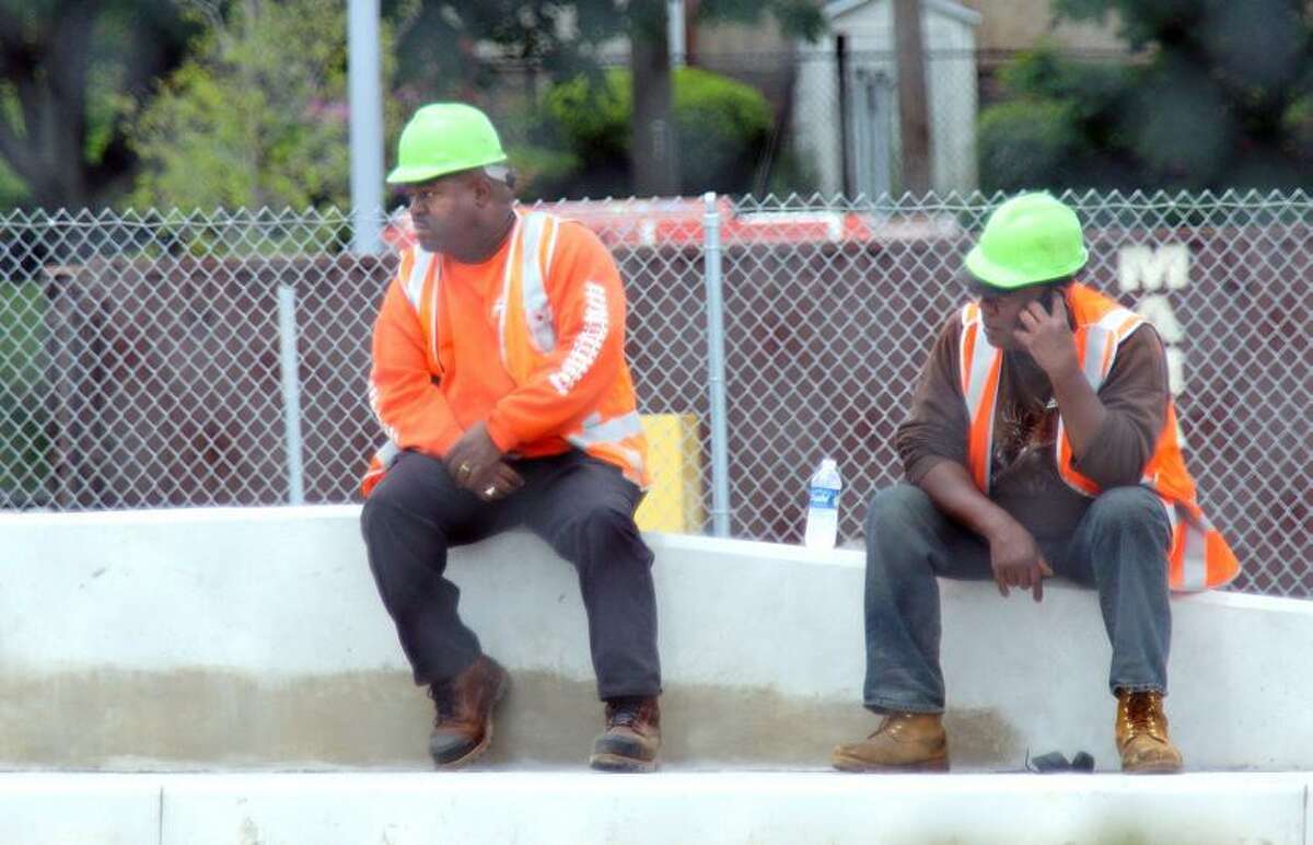 West Haven--Metro North workers at the West Haven train station, where a worker was killed by a Metro North train, while working on the tracks. Photo-Peter Casolino/Register pcasolino@newhavenregister.com