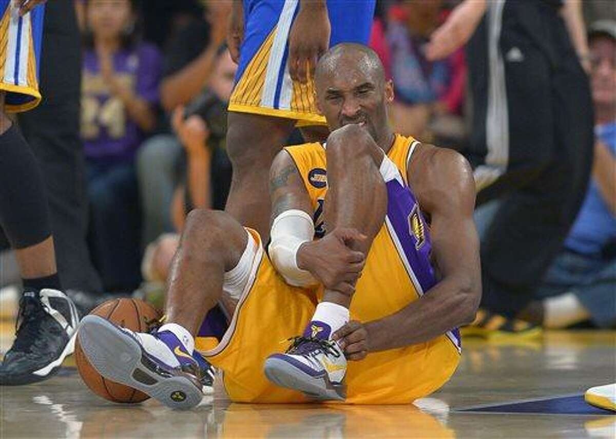 Los Angeles Lakers guard Kobe Bryant grimaces after being injured during the second half of their NBA basketball game against the Golden State Warriors, Friday, April 12, 2013, in Los Angeles. The Lakers won 118-116. (AP Photo/Mark J. Terrill)