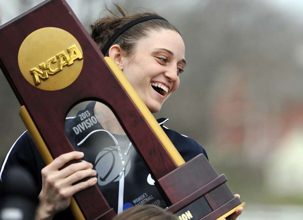 Connecticut's Kelly Faris holds the championship trophy during a parade through campus honoring the team's win in the women's NCAA Final Four college basketball championship in Storrs, Conn., Wednesday, April 10, 2013. (AP Photo/Jessica Hill)