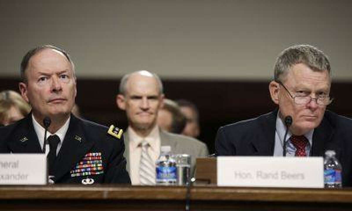 General Keith Alexander, left, commander of the U.S. Cyber Command, director of the National Security Agency and chief of the Central Security Service, and Rand Beers, acting deputy secretary of the Department of Homeland Security, testify before the Senate Appropriations Committee hearing on Cybersecurity: Preparing for and Responding to the Enduring Threat, on Capitol Hill in Washington June 12, 2013.
