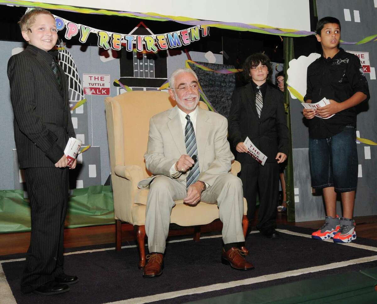 Peter Hvizdak -- RegisterAnthony Serio, retiring as East Haven Superintendent of Schools, second from left, is honored Wednesday June 12, 2013 by the Grove J. Tuttle Elementary School during its'"Tuttle Talk" school assembly, a television style talk show program produced by students at the school. The students on stage with Serio are from left, fifth graders Logan Hamilton, Michael Streeto, and Andre Rentlas.
