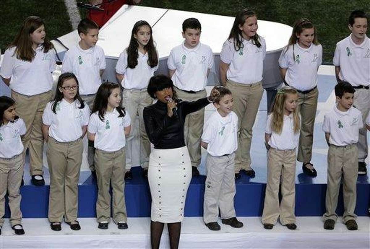 Jennifer Hudson performs with students from Sandy Hook Elementary School singing "America the Beautiful" before the NFL Super Bowl XLVII football game between the San Francisco 49ers and the Baltimore Ravens, Sunday, Feb. 3, 2013, in New Orleans. (AP Photo/Gerald Herbert)