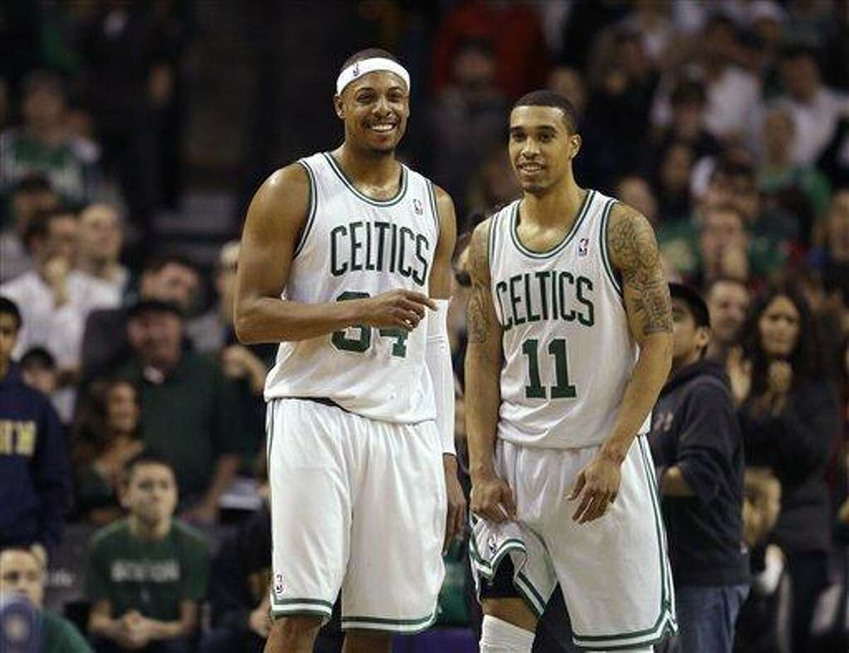Boston Celtics forward Paul Pierce (34), left, and Celtics guard Courtney Lee (11), right, react seconds after the end of an NBA basketball game against the Los Angeles Clippers in Boston, Sunday, Feb. 3, 2013. The Celtics defeated the Clippers 106-104. (AP Photo/Steven Senne)