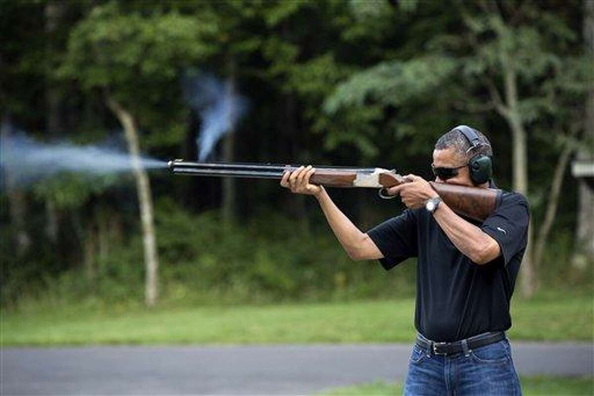 In this photo released by the White House, President Barack Obama shoots clay targets on the range at Camp David, Md., Saturday, Aug. 4, 2012. The White House released a photo of Obama firing a gun, two days before he heads to Minnesota to discuss gun control. In a recent interview with The New Republic magazine, Obama said yes when asked if he has ever fired a gun. He said "we do skeet shooting all the time," except for his daughters, at Camp David. (AP Photo/The White House, Pete Souza)