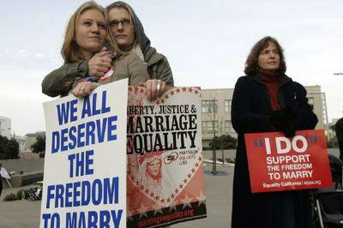 In this file photo, same-sex couple Elizabeth Chase (L) and Kate Baldridge stand outside the federal courthouse in San Francisco, Calif. (Robert Galbraith/Reuters)