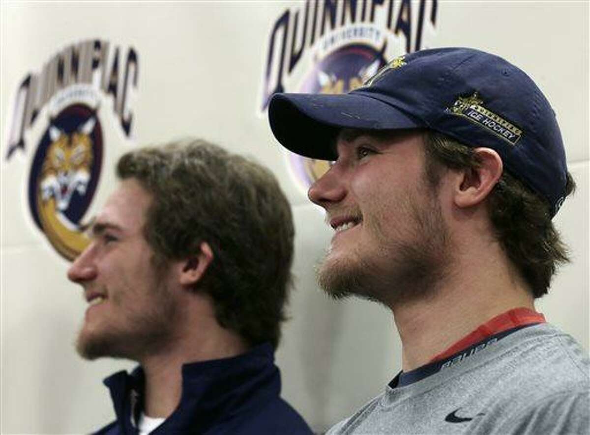 Quinnipiac forward Connor Jones, right, smiles with his twin brother Kellen, who is also a Quinnipiac forward, during a news conference at the university in Hamden, Conn., Tuesday, April 2, 2013. Quinnipiac will face North Dakota in a national semifinal at the NCAA hockey Frozen Four. (AP Photo/Charles Krupa)
