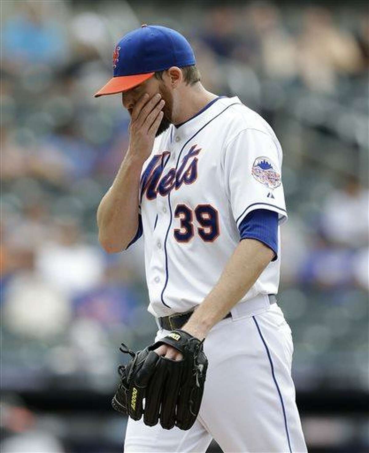 New York Mets relief pitcher Bobby Parnell (39) reacts leaving the mound after Mets manager Terry Collins removed Parnell from the game in the tenth-inning of the Mets 8-4 loss to the Miami Marlins in a baseball game in New York, Sunday, June 9, 2013. Parnell allowed two hits to the Marlins and Adeiny Hechavarria reached on Daniel Murphy's fielding error allowing Logan Morrison to score the go-ahead run. (AP Photo/Kathy Willens)