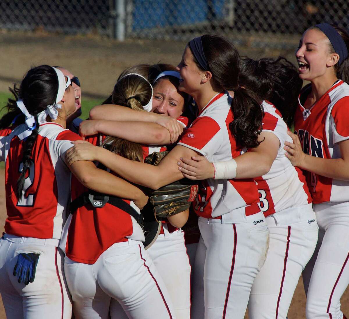 Foran pitcher Jessica Harkness, center, celebrates with her teammates after Foran beat Maloney 5-4 for the Class L state softball semifinal. Photo-Peter Casolino/Register pcasolino@newhavenregister.com
